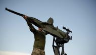 A soldier of a mobile anti-aircrafts brigade prepares a 12.7mm calibre heavy machine gun near a training field in the Khmelnytsky region, on July 8, 2024. (Photo by Florent VERGNES / AFP)
