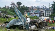 Security personnel inspect the remains of a Saurya Airlines flight after it crashed during takeoff at Tribhuvan International Airport in Kathmandu on July 24, 2024. Photo by PRAKASH MATHEMA / AFP