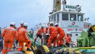 Coast guard personnel load the skimmers to be used in the oil spill response, at a port in Limay, Bataan on July 26, 2024. Photo by Jam Sta Rosa / AFP