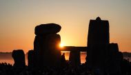 The sun rises at Stonehenge, near Amesbury, in Wiltshire, southern England on June 21, 2024, during the Summer Solstice festival, which dates back thousands of years, celebrating the longest day of the year when the sun is at its maximum elevation. Photo by William EDWARDS / AFP