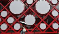 A woman walks by the Olympic park in Beijing on August 2, 2024. (Photo by ADEK BERRY / AFP)

