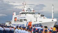 Philippine Coast Guard personnel wave flags as a Vietnam Coast Guard ship makes a port call during a goodwill visit at a port in Manila on August 5, 2024. Photo by JAM STA ROSA / AFP.