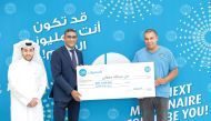 QIB officials presenting the award to a winner.