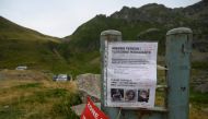 A missing person sign for British hiker Tom Doherty is seen attached to a metal post near Ustou, in the French Pyrenees between Col d'Escots and Cirque de Gerac on August 11, 2024. (Photo by Ed JONES / AFP)