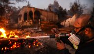 Volunteers attempt to extinguish a wildfire in Vrilissia, on the outskirts of Athens on August 12, 2024. Photo by Aris Oikonomou / AFP.