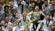 Real Madrid's player celebrate with the trophy after the UEFA Super Cup football match between Real Madrid and Atalanta BC in Warsaw, on August 14, 2024. (Photo by Sergei GAPON / AFP)
