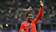 Gold medallist Kenya's Faith Kipyegon celebrates on the podium after competing in the women's 1500m final of the athletics event during the Paris 2024 Olympic Games at Stade de France in Saint-Denis, north of Paris, on August 10, 2024. (Photo by MARTIN BERNETTI / AFP)
