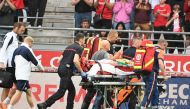 Lille's English forward Angel Gomes is evacuated on a stretcher off the pitch after being injured during the French L1 football match between Stade de Reims and Lille LOSC at the Stade Auguste-Delaune in Reims, northern France, on August 17, 2024. (Photo by FRANCOIS NASCIMBENI / AFP)

