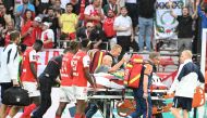 Rennes' players walk next to Lille's English forward Angel Gomes evacuated on a stretcher off the pitch after being injured during the French L1 football match between Stade de Reims and Lille LOSC at the Stade Auguste-Delaune in Reims, northern France, on August 17, 2024. (Photo by FRANCOIS NASCIMBENI / AFP)
