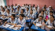 College students attend a maths lesson for the first time in weeks during the reopening of schools after a long halt due to the violence surrounding anti-government protests that resulted in the resignation of Sheikh Hasina at the Viqarunnisa Noon School and College in Dhaka on August 18, 2024. Photo by LUIS TATO / AFP.