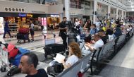 Passengers wait for their flights at the Beirut International Airport in Beirut yesterday. (AFP)