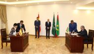 In this handout photograph taken and released by La Moncloa on August 27, 2024 Mauritanian President Mohamed Ould Cheikh Ghazouani (C,R) and Spanish Prime Minister Pedro Sanchez (C,L) attend the signing of agreement by Spain's Minister for Inclusion, Migration and Social Security Elma Saiz (L) and her Mauritanian couterpart in Nouakchott. Photo by Fernando CALVO / LA MONCLOA / AFP.
