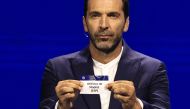 Italy's former goalkeeper Gianluigi Buffon shows the paper slip of Atletico Madrid (ESP) during the group stage of the 2024-2025 UEFA Champions League football tournament, at the Grimaldi Forum in Monaco on August 29, 2024. (Photo by Valery Hache / AFP)