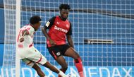 Leipzig's Belgian forward #11 Lois Openda scores the 2-3 goal past Bayer Leverkusen's Burkinabe defender #12 Edmond Tapsoba during the German first division Bundesliga football match between Bayer 04 Leverkusen and RB Leipzig in Leverkusen, southwestern Germany on August 31, 2024. (Photo by UWE KRAFT / AFP)
