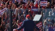 Supporters cheer as Former US President and 2024 Republican presidential candidate Donald Trump speaks during a rally at the Central Wisconsin Airport in Mosinee, Wisconsin, on September 7, 2024. (Photo by Alex Wroblewski / AFP)