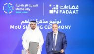 CEO of Media City Qatar Eng. Jassim Mohamed Al Khori (left) and CEO of Fadaat Media Group Maayed Dib exchange documents after signing the agreement.