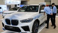 Attendees look at a BMW iX5 Hydrogen Fuel Cell Powered SUV car at the World Climate Industry Expo (2024 WCE) held at BEXCO in Busan on September 4, 2024. (Photo by ANTHONY WALLACE / AFP)