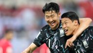 South Korea's forward and captain #07 Son Heung-min celebrates with his striker #11 Hwang Hee-chan after the latter scored a goal during the 2026 FIFA World Cup Asian qualification football match between Oman and South Korea in Muscat on September 10, 2024. (Photo by Haitham AL-SHUKAIRI / AFP)