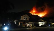 People watch (C) the Airport Fire burning on a hill above homes on September 9, 2024 in Trabuco Canyon, California. Pictures: Mario Tama/Getty Images/AFP 