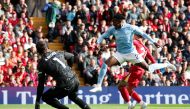 Nottingham Forest's Swedish midfielder #21 Anthony Elanga (front R) jumps for the ball during the English Premier League football match between Liverpool and Nottingham Forest at Anfield in Liverpool, north west England on September 14, 2024. (Photo by Ian Hodgson / AFP) 