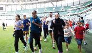 Olympic marathon champion Sifan Hassan (third left) participates in a run after the launch of the Creating Pathways Program at the Education City Stadium yesterday. 
