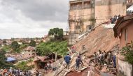 Rescue workers search through rubbles for survivors after a seven story building collapsed in Freetown on September 16, 2024. (Photo by Saidu Bah / AFP)