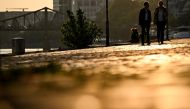 Pedestrians walk on the river Main embankment during sunset in Frankfurt am Main, western Germany, on September 18, 2024.
(Photo by Kirill KUDRYAVTSEV / AFP)
