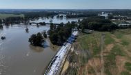 This aerial photograph taken on September 21, 2024 shows the bank of the Oder river protected with sandbags against the floods in Brzeg Dolny. Photo by Sergei GAPON / AFP