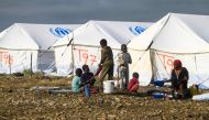 Displaced Sudanese who have returned from Ethiopia gather in a camp run by the United Nations Refugee Agency (UNHCR) in Sudan's border town of Gallabat in the eastern state of Gadaref on September 11, 2024. (Photo by Ebrahim Hamid / AFP)
