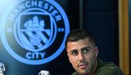Manchester City's Spanish midfielder #16 Rodri reacts during a press conference at the Manchester City's training ground, in Manchester, north-west England, on September 17, 2024, on the eve of their UEFA Champions League football match against Inter Milan. (Photo by Oli SCARFF / AFP)

