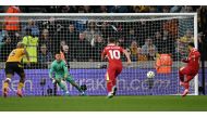 Liverpool's Egyptian striker #11 Mohamed Salah scores the team's second goal from the penalty spot during the English Premier League football match between Wolverhampton Wanderers and Liverpool at the Molineux stadium in Wolverhampton, central England on September 28, 2024. (Photo by Paul ELLIS / AFP) 
