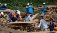 (Files) This file photo taken on September 23, 2024 shows Takaya Kiso (C) searching for his missing daughter among debris. (Photo by Yuichi Yamazaki / AFP)
 