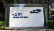 A man walks past a signboard of Samsung Electronics outside the company's Seocho building in Seoul on October 8, 2024. Photo by Jung Yeon-je / AFP