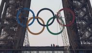 The Olympic rings are seen on the Eiffel Tower before an unveiling ceremony in Paris, early on June 7, 2024, ahead the upcoming Paris 2024 Olympic Games. (Photo by JOEL SAGET / AFP)

