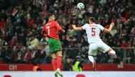 Portugal's forward #07 Cristiano Ronaldo and Poland's defender #05 Jan Bednarek both jump to head the ball during the UEFA Nations League in Warsaw, Poland on October 12, 2024. (Photo by Sergei Gapon / AFP)
 