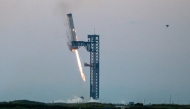 Starship's Super Heavy Booster is grappled at the launch pad in Starbase near Boca Chica, Texas, on October 13, 2024, during the Starship Flight 5 test. SpaceX successfully 