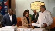 US Vice President and Democratic presidential candidate Kamala Harris helps pack supplies for those affected by Hurricane Helene during a campaign stop at The Pit Authentic Barbecue restaurant in Raleigh, North Carolina, on October 12, 2024. (Photo by Brendan Smialowski / AFP)