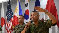 Japan's Ground Self-Defense Force Major-General Hajime Kitajima (R) speaks as US Marines exercise representative Colonel Stuart Glenn looks on during a press conference following the opening ceremony of the Kamandag 2024 joint military exercise at the Philippine Marines officers club at Fort Bonifacio in Manila on October 15, 2024. (Photo by Ted Aljibe / AFP)
