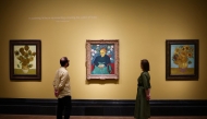 Photo used for demonstration purposes. Visitors look at (from L) three paintings made by late Dutch artist Vincent Van Gogh 
