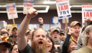 Ryan Bergh, a machinist at Boeing's factory in Everett, Washington for 10 years, cheers during a strike rally for the International Association of Machinists and Aerospace Workers (IAM) at the Seattle Union Hall in Seattle, Washington, on October 15, 2024. Photo by Jason Redmond / AFP.