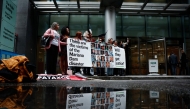 Victims and relatives of victims of the dam rupture gather outside the Rolls building of the High court of Justice in London, on October 21, 2024, on the opening day of the trial of the mining company BHP's responsibilities over 2015 toxic Brazil mine disaster. Photo by BENJAMIN CREMEL / AFP