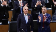 The Chairman of Austria's Freedom Party (FPOe) Herbert Kickl (R) and other MPs applaud after the election of Walter Rosenkranz (L), MP of Austria's Freedom Party (FPOe), as new parliament president in the plenary of the Austrian Parliament in Vienna on October 24, 2024, as the parliament meets for the first time after the National Council elections. (Photo by Alex HALADA / AFP)
