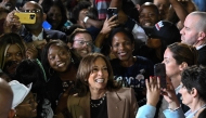 US Vice President and Democratic presidential candidate Kamala Harris takes a picture with supporters at the end of a campaign rally at the James R Hallford Stadium in Clarkston, Georgia on October 24, 2024. (Photo by Drew Angerer / AFP)