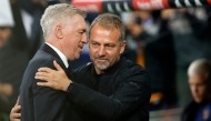 Real Madrid's Italian coach Carlo Ancelotti (L) and Barcelona's German coach Hans-Dieter Flick hug each other before the Spanish league football match between Real Madrid CF and FC Barcelona at the Santiago Bernabeu stadium in Madrid on October 26, 2024. (Photo by OSCAR DEL POZO / AFP)

