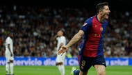 Barcelona's Polish forward #09 Robert Lewandowski celebrates scoring his team's second goal during the Spanish league football match between Real Madrid CF and FC Barcelona at the Santiago Bernabeu stadium in Madrid on October 26, 2024. (Photo by OSCAR DEL POZO / AFP)
