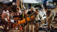 Members of Spain's military clear debris from streets on November 2, 2024, in the aftermath of deadly floods in the town of Benetusser, in the region of Valencia, eastern Spain. Photo by Manaure Quintero / AFP.