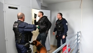 Photo used only for demonstration purposes. French police officers, helped by a dog, check a potential drug stash, during a 