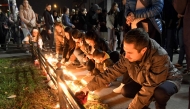 Local residents light candles near the train station in the northern Serbian city of Novi Sad on November 2, 2024, the day after an outdoor concrete roof of the station collapsed. Photo by NENAD MIHAJLOVIC / AFP