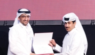 Minister of Justice and Minister of State for Cabinet Affairs H E Ibrahim bin Ali Al Mohannadi presents certificate to a graduate.