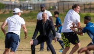 Britain's Prince William (C), Prince of Wales, plays rugby with students during his visit at the Ocean View Secondary School in Cape Town on November 4, 2024. (Photo by Jerome Delay / POOL / AFP)
